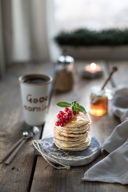 Sweet pancakes with currant berries and honey