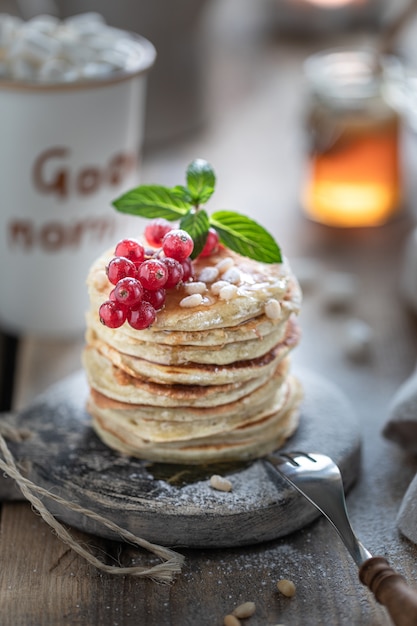 Sweet pancakes with currant berries and honey