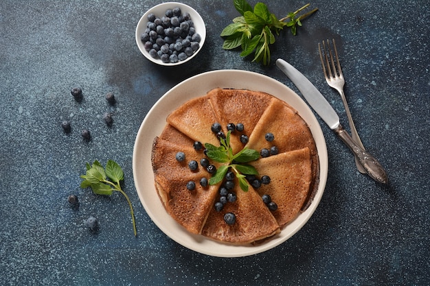 Sweet pancakes wrapped with fresh mint and blueberries.