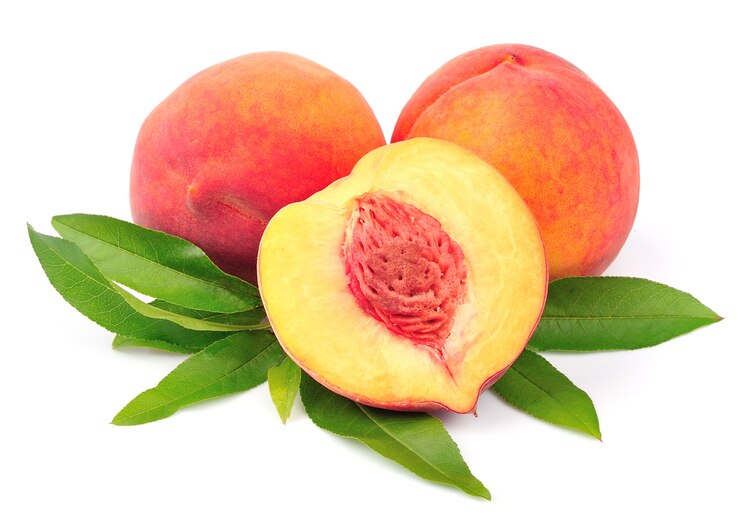 Sweet peach with leaves close up on white