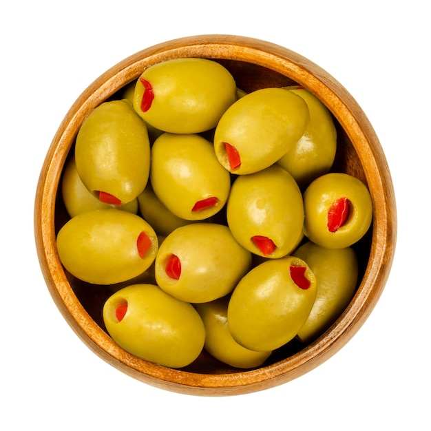 Sweet pepper stuffed olives in wooden bowl