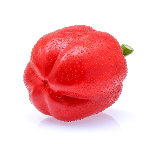 Sweet pepper with drops of water on white background.