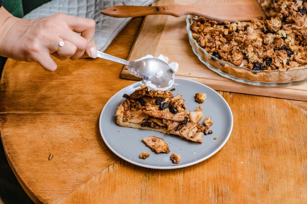 Sweet pie with apples and nuts on a blue plate