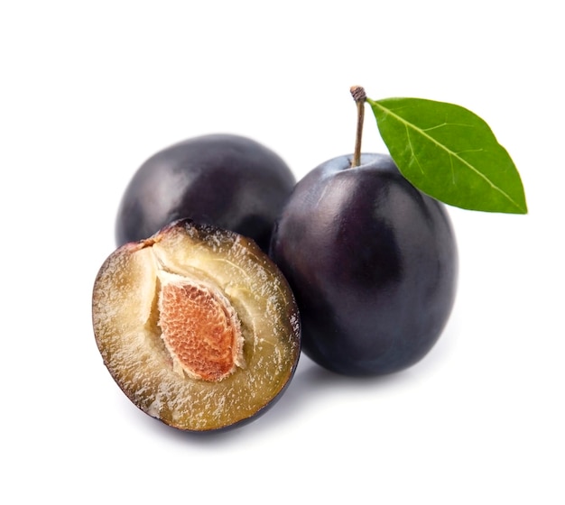 Sweet plums with leaves on white backgrounds