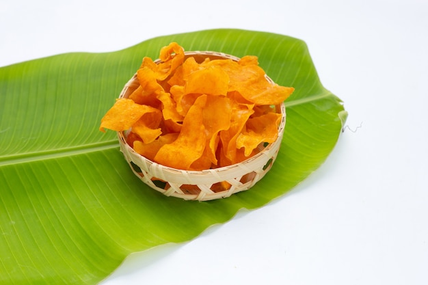 Sweet potato chips in bamboo basket on banana leaf