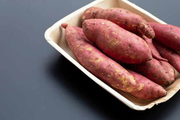 Sweet potato on dark background.