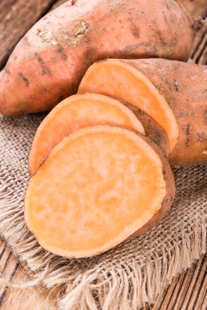 Sweet Potato uncooked on wooden background