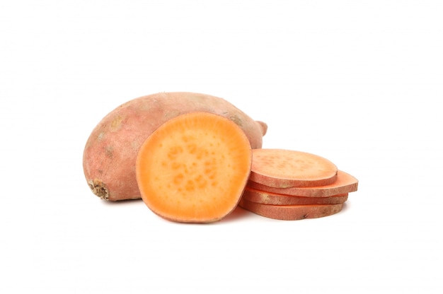 Sweet potatoes and slices isolated on white surface