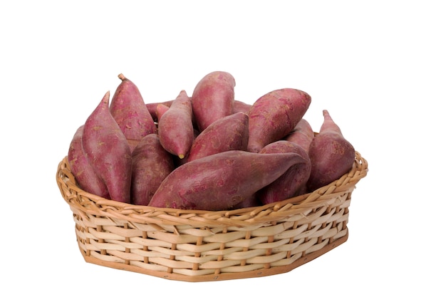 Sweet potatoes in wicker basket on white background