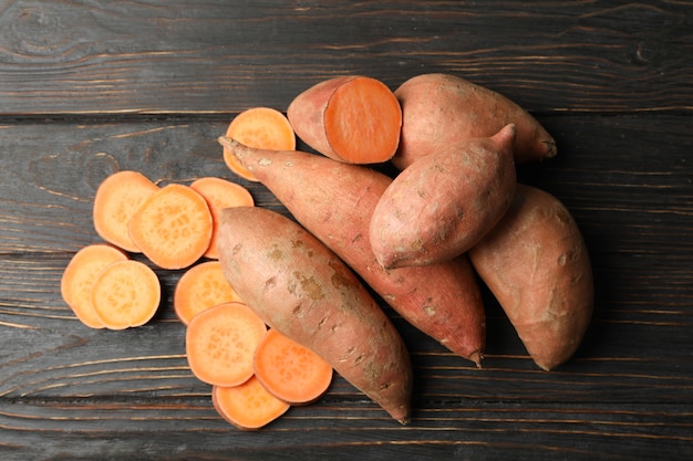 Sweet potatoes on wooden surface