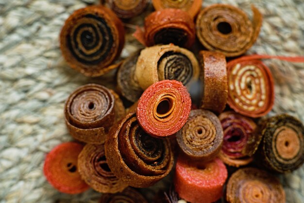 Sweet pureed fruit pastille. Fruit roll-ups homemade. Natural sweets from dried berries and fruits.