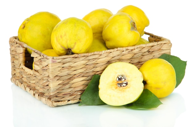 Sweet quinces in wicker basket isolated on white