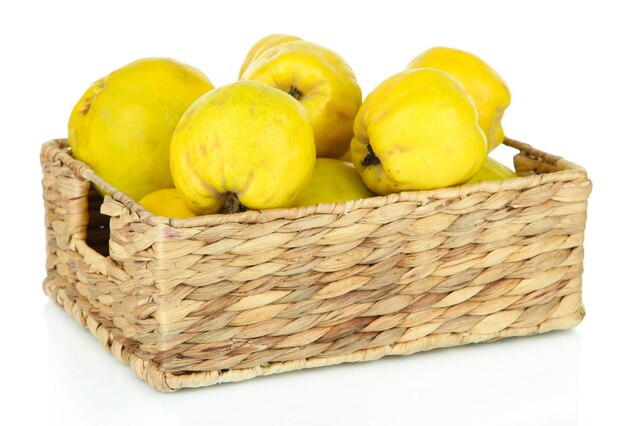 Sweet quinces in wicker basket isolated on white