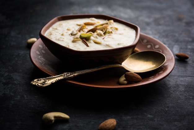 Sweet Rabdi or Lachha Rabri or basundi, made with pure milk garnished with dry fruits. Served in a bowl over moody background. Selective focus