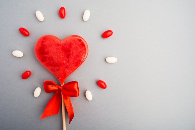 Sweet red candy heart symbol of love with sweet shine background