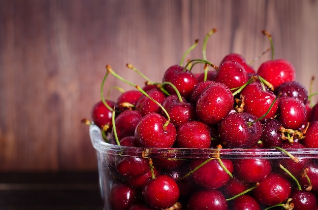 Sweet red cherries in glass bowl. Summer and harvest concept. Vegan, vegetarian, raw food