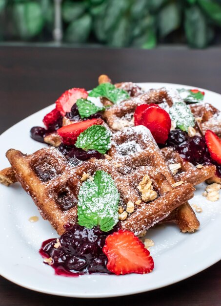 Sweet red fruit waffles with icing sugar