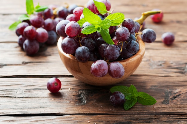 Sweet red grapes on the wooden table