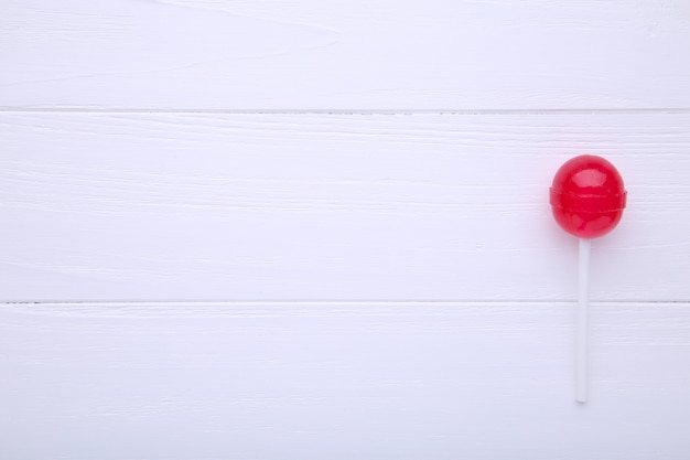 Sweet red lollipop on white table. sweet candy concept