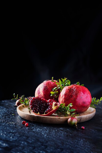 Sweet red pomegranate with green leaves