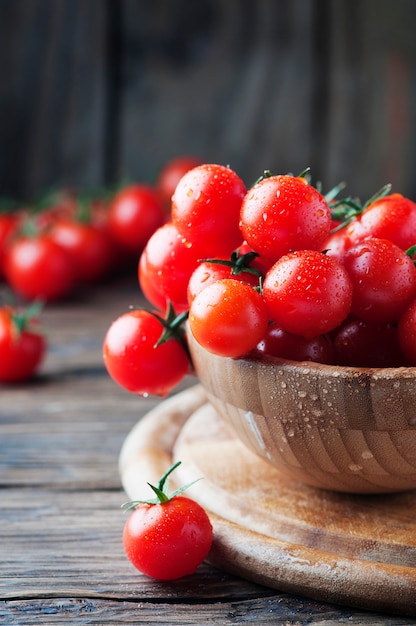 Sweet red tomatoes on the wooden table, selective focus