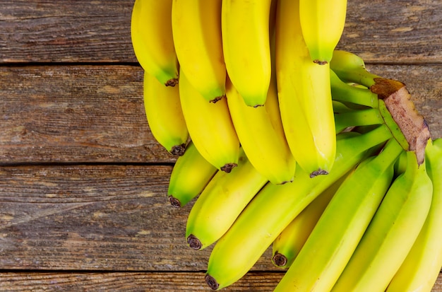 Sweet ripe bananas on a wooden table.