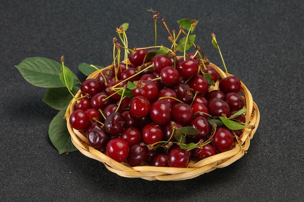 Sweet ripe cherry heap with leaves