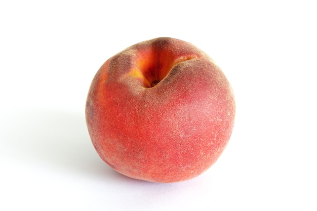 Sweet ripe juicy peaches with green leaves on a wooden background