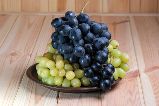 Sweet ripe white and black unwashed grapes