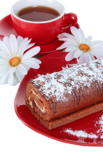 Sweet roll with cup of tea isolated on white