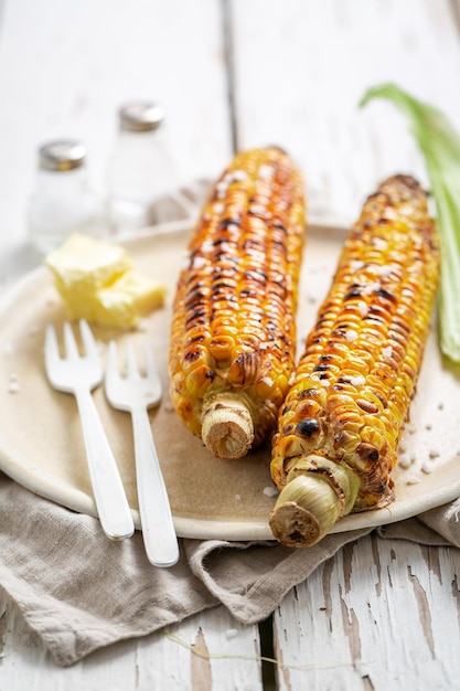 Sweet and salty grilled corn cob with salt and butter