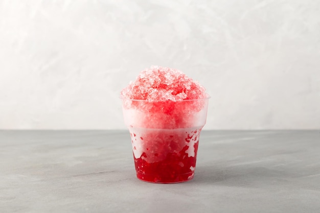 Sweet shaved ice or Spanish granizado Red Slushie drink with natural juice Refreshing summer drink