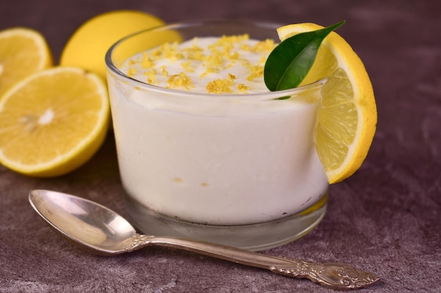 Sweet and sour creamy lemon dessert in glasses Closeup