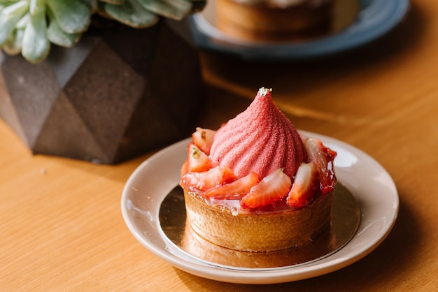 Sweet strawberry cupcake on the wooden table