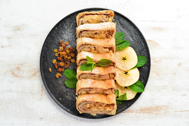 Sweet Strudel with apples and dried fruits Top view free copy space