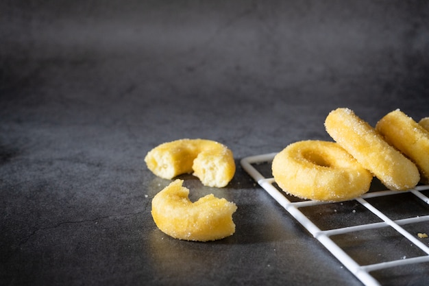  sweet sugar donuts on dark background