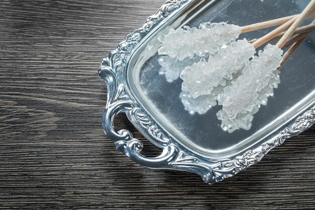 Sweet sugar sticks tray on wooden board