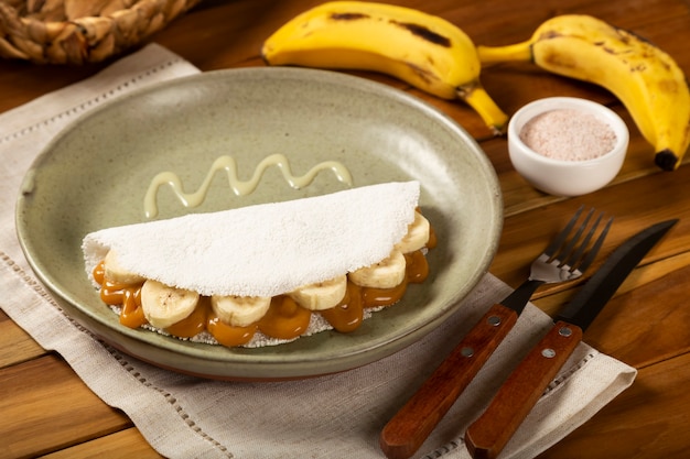 Sweet tapioca stuffed with dulce de leche and banana Brazilian tapioca