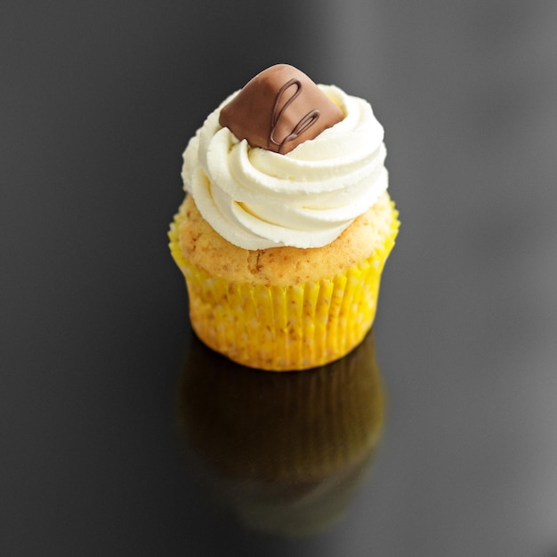 Sweet tasty cupcake with cream and candy The concept of food desserts holiday