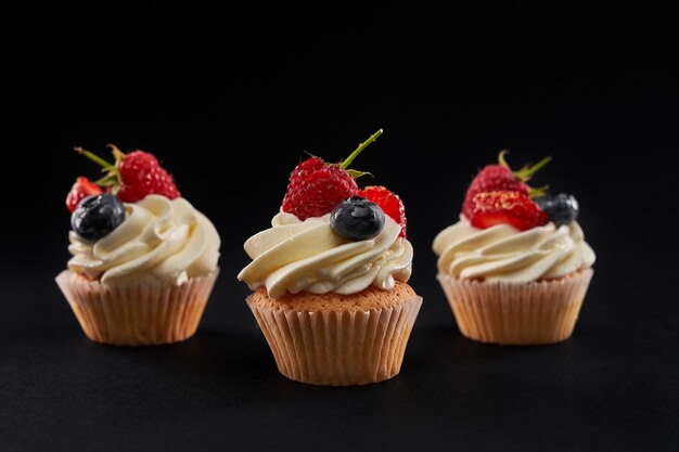 Sweet tasty cupcakes in row isolated