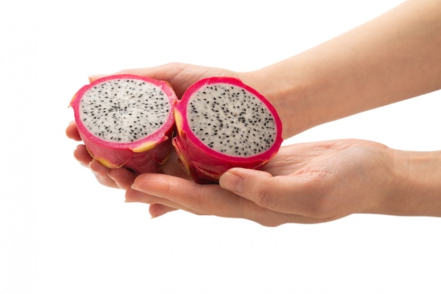 Sweet tasty dragon fruit or pitaya in woman hand isolated.