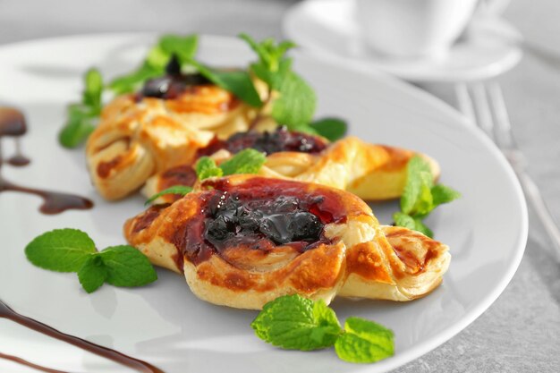 Sweet tasty pastries on plate closeup