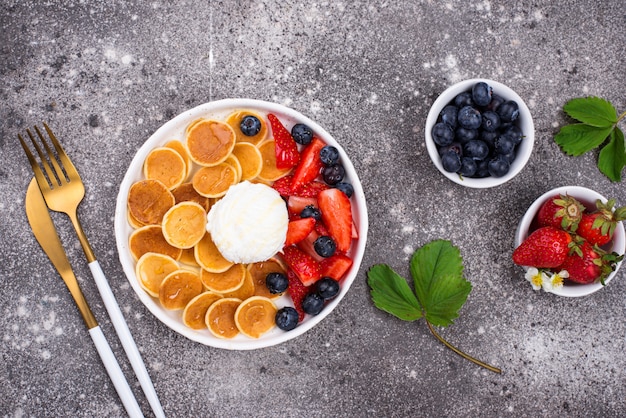 Sweet tiny pancake cereals with berries