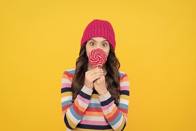 Sweet tooth yummy surprised teen girl hold lollipop lollipop lady kid with colorful lollypop