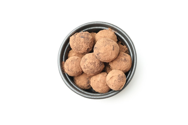 Sweet truffles in bowl isolated on white background