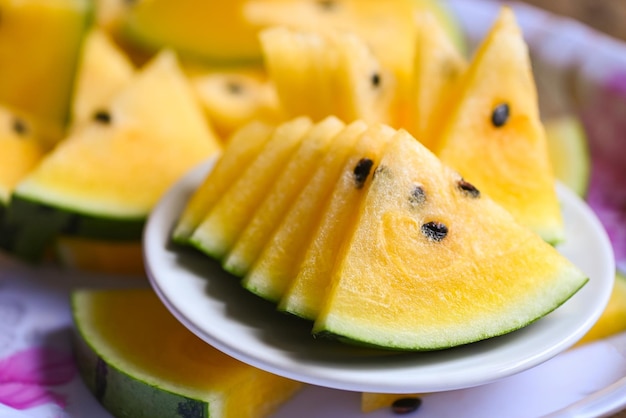 Sweet watermelon slices pieces fresh watermelon tropical summer fruit Yellow watermelon slice on plate
