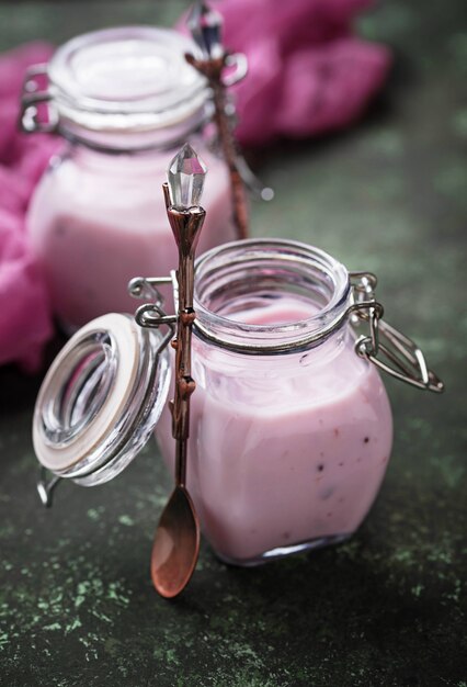 Sweet yogurt with berry in a glass jars
