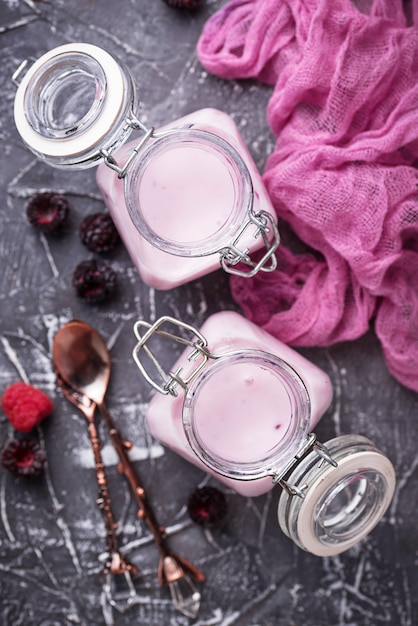 Sweet yogurt with berry in a glass jars