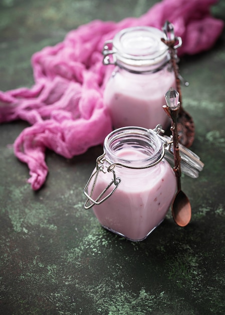 Sweet yogurt with berry in a glass jars