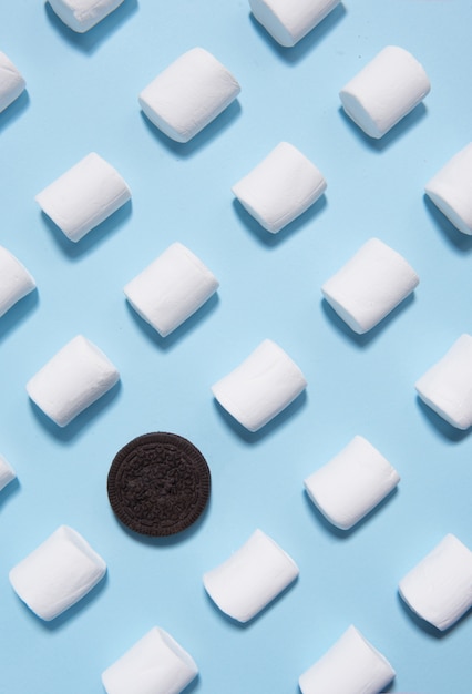 Sweeties marshmallows over blue table background.